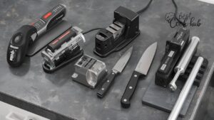 Bestcookhub - Various types of knife sharpeners (electric, whetstone, pull-through, honing rod) arranged on a kitchen counter with knives beside them